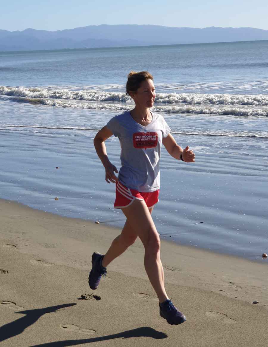 Tanya running the beach while training for an Ultra Marathon